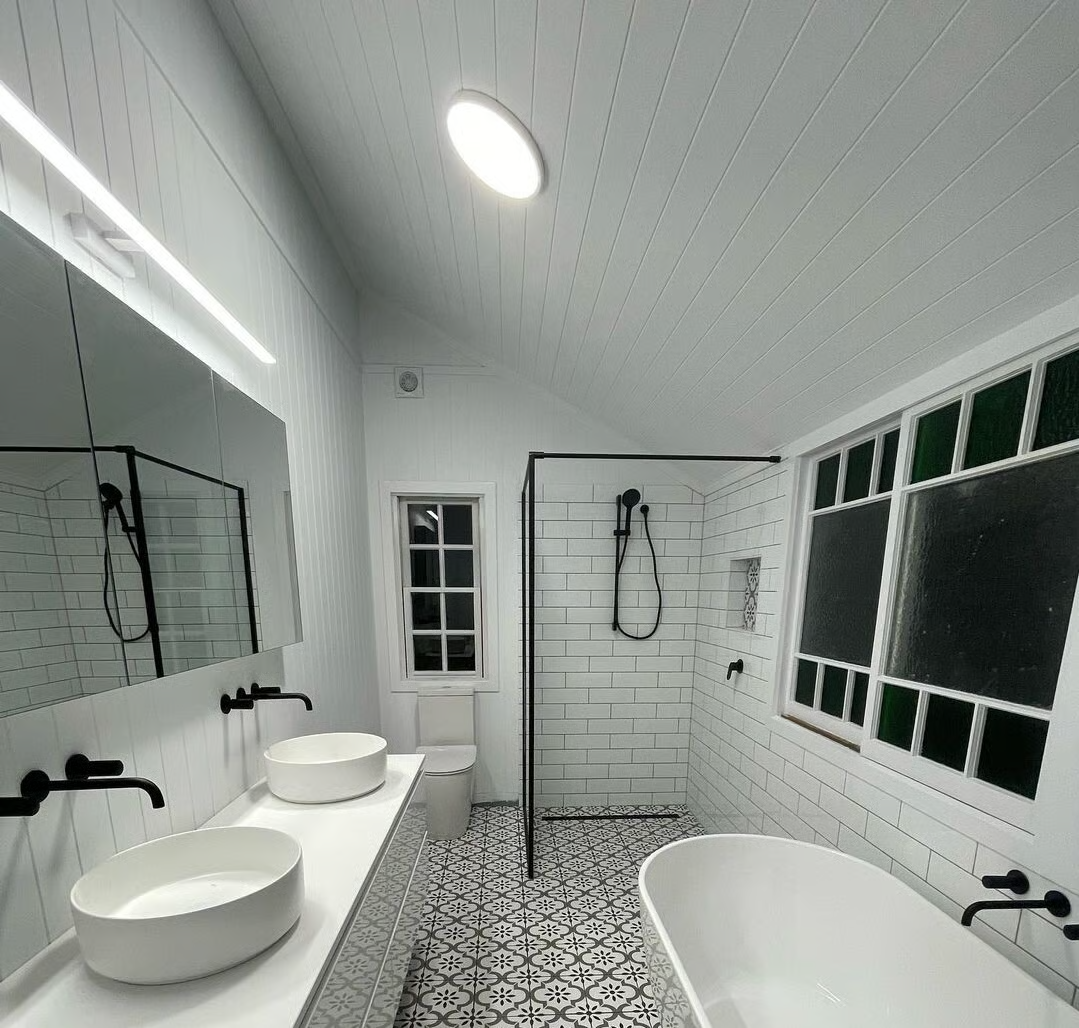 Modern bathroom vanity featuring an elegant arched mirror.